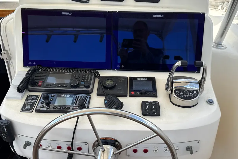 Slide: The Image of Helm of 2000 Dawson Yachts Express with dual Simrad displays and navigation controls. - 14
