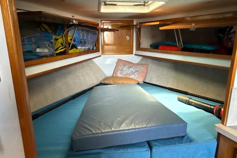 Slide: The Image of Cozy cabin interior of 2000 Dawson Yachts Express with cushions and storage. - 17