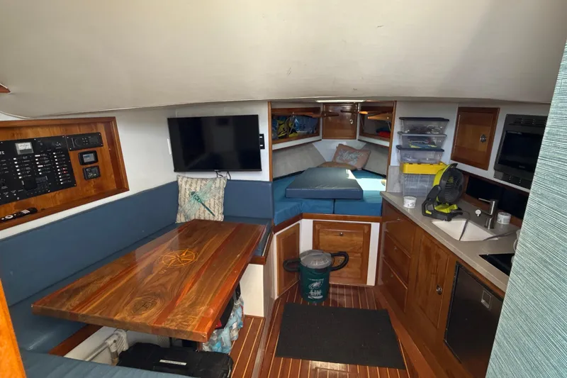 Slide: The Image of Interior of 2000 Dawson Yachts Express, featuring cozy seating, kitchenette, and sleeping area. - 20