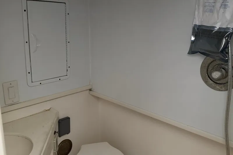 Slide: The Image of Interior of 2000 Dawson Yachts Express bathroom with shower and storage compartment. - 21