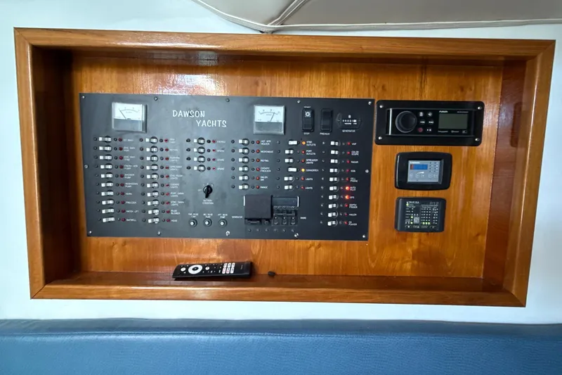 Slide: The Image of Control panel of a 2000 Dawson Yachts Express, featuring switches and meters. - 23