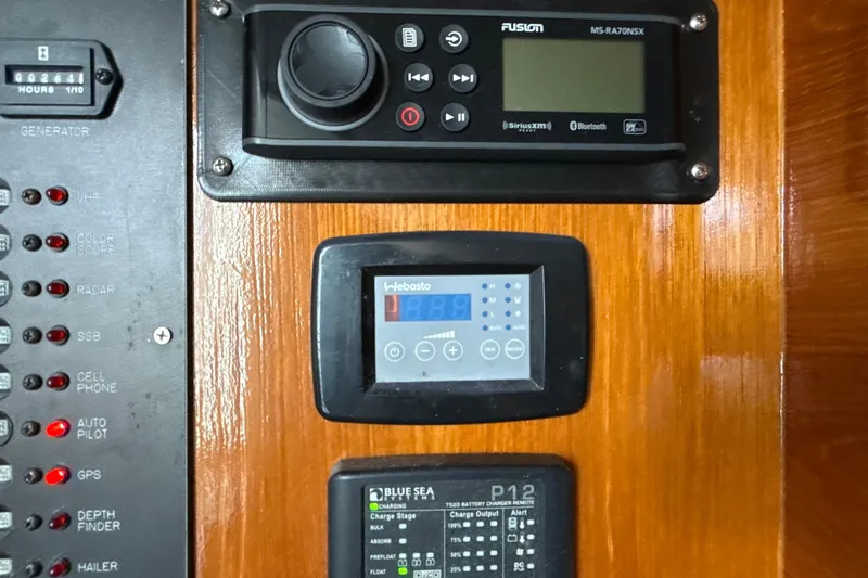 Slide: The Image of Control panel of a 2000 Dawson Yachts Express with electronic displays and switches. - 24