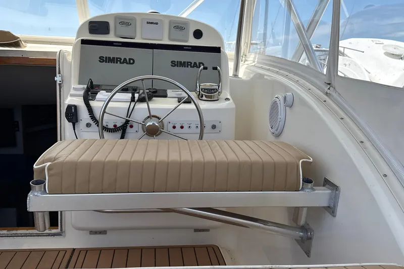 Slide: The Image of Helm of 2000 Dawson Yachts Express with Simrad electronics and cushioned seating. - 26