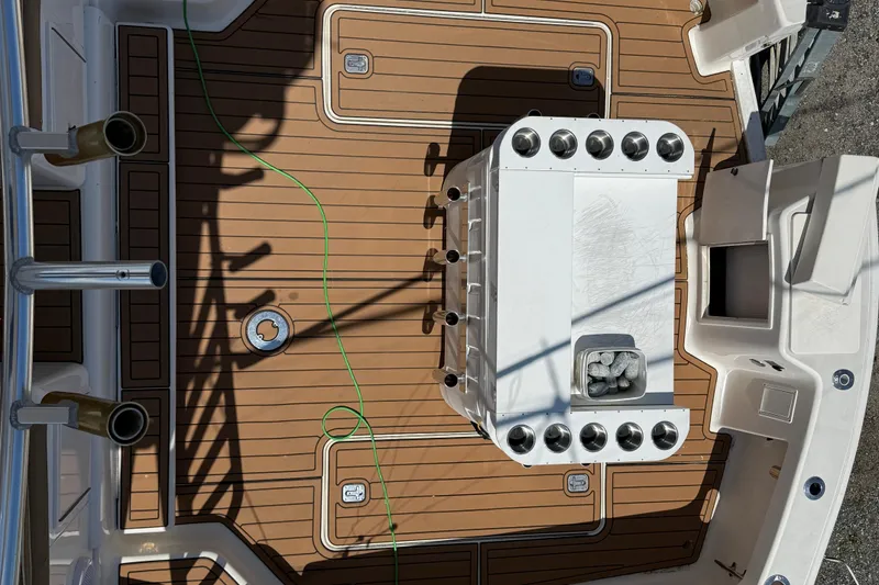 Slide: The Image of Dawson Yachts 2000 Express deck with rod holders and storage compartments. - 27