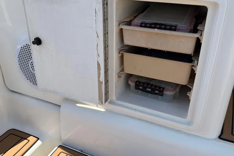 Slide: The Image of Storage compartment on a 2000 Dawson Yachts Express, featuring organized tackle boxes. - 28