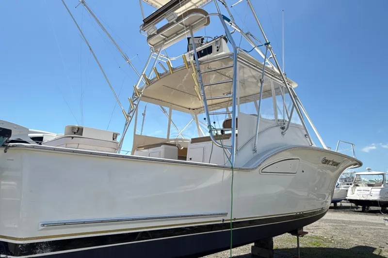 Slide: The Image of 2000 Dawson Yachts Express boat with tower, docked under clear blue sky. - 3