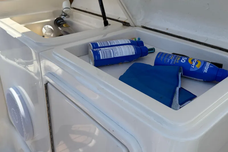 Slide: The Image of Storage compartment on 2000 Dawson Yachts Express with sunscreen and cleaning supplies. - 30