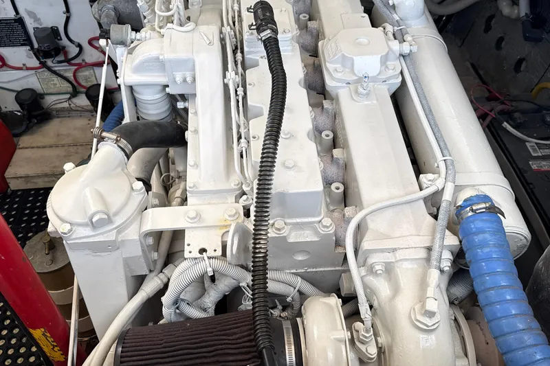 Slide: The Image of Engine compartment of a 2000 Dawson Yachts Express, showcasing detailed mechanical components. - 33