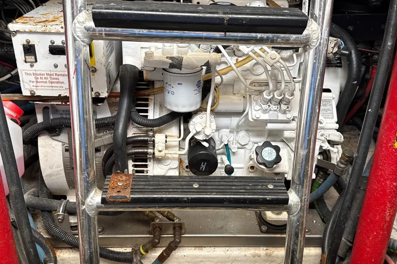 Slide: The Image of Engine compartment of a 2000 Dawson Yachts Express, featuring mechanical components and wiring. - 36