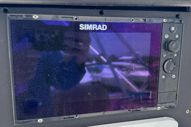 Slide: The Image of Simrad navigation system on a 2000 Dawson Yachts Express, showing screen and control buttons. - 37