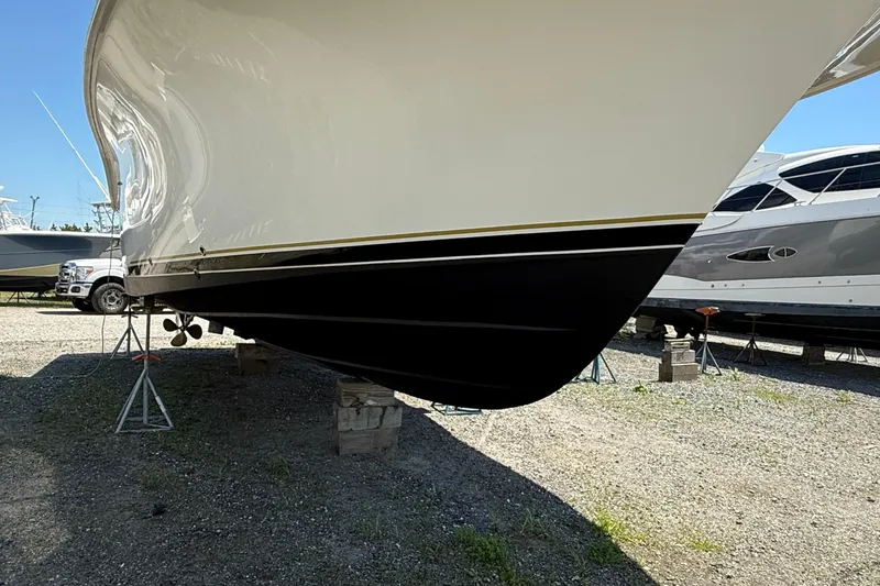 Slide: The Image of 2000 Dawson Yachts Express on stands, showcasing sleek hull design in a boatyard. - 5