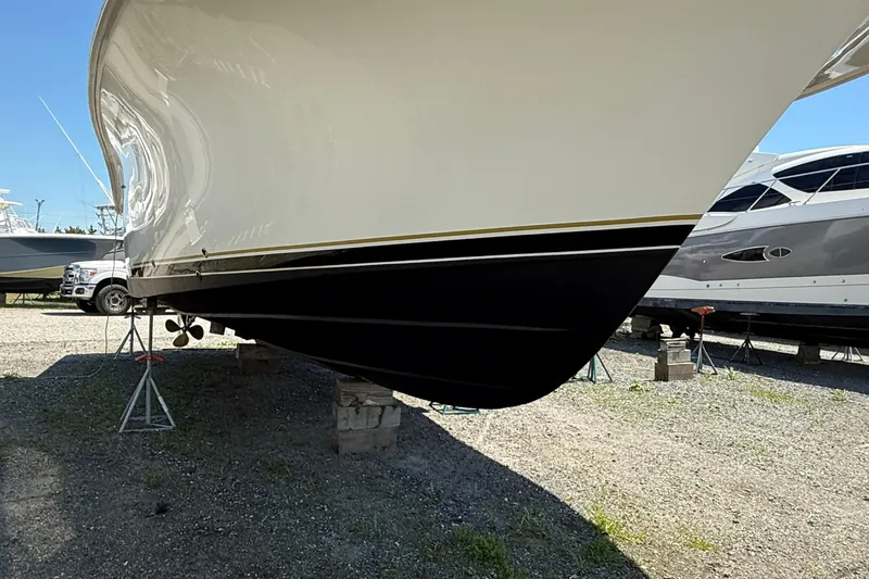 Slide: The Image of Dawson Yachts Express 2000 model on dry dock, showcasing sleek hull design. - 6