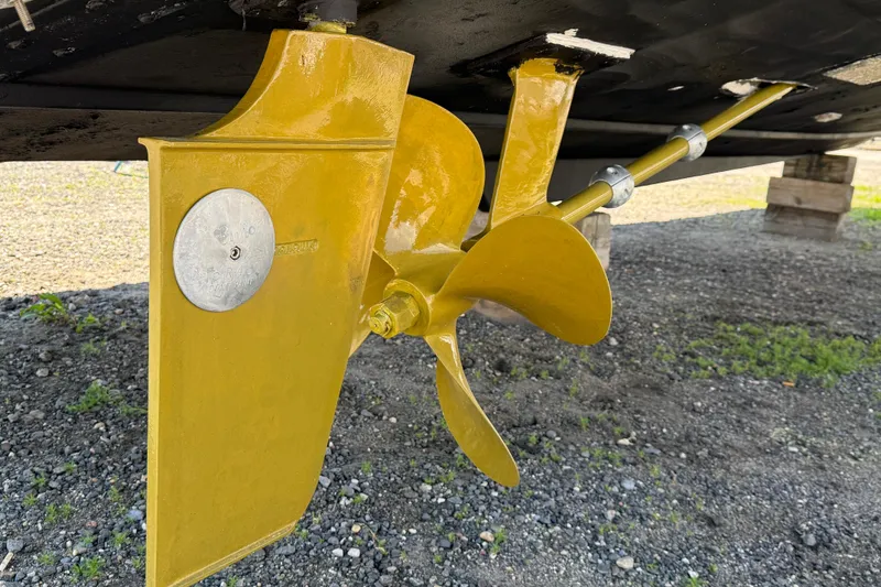 Slide: The Image of Yellow propeller and rudder of a 2000 Dawson Yachts Express on dry land. - 7