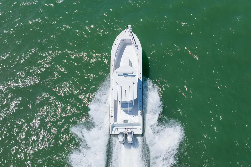 Slide: The Image of Aerial view of 2007 Yellowfin 34 Offshore boat cruising on green water. - 12