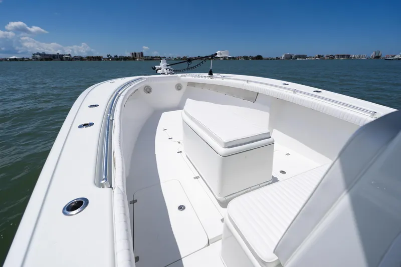 Slide: The Image of 2007 Yellowfin 34 Offshore boat interior with seating, on calm water under clear blue sky. - 13