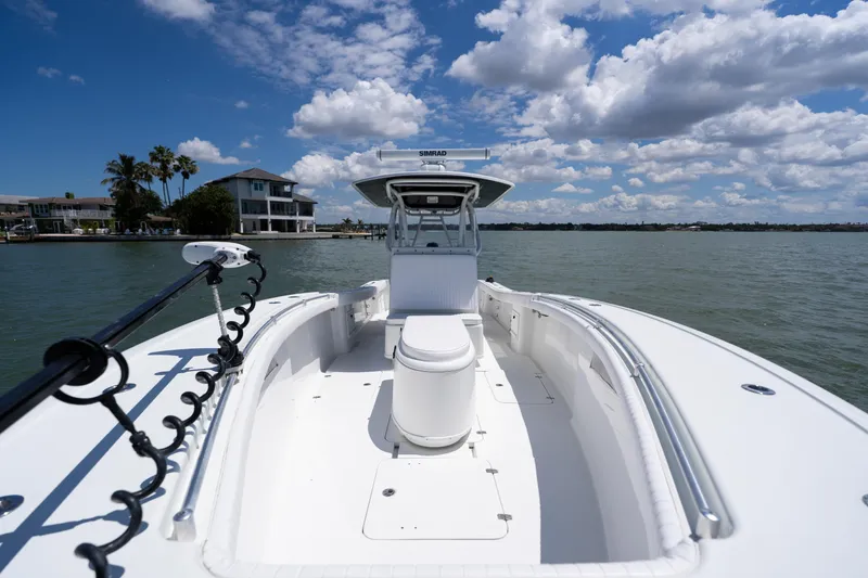 Slide: The Image of 2007 Yellowfin 34 Offshore boat on water, clear sky, coastal background. - 17