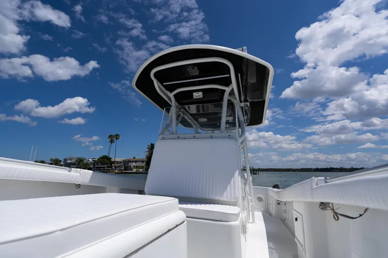 Slide: The Image of 2007 Yellowfin 34 Offshore boat under a bright blue sky with scattered clouds. - 18