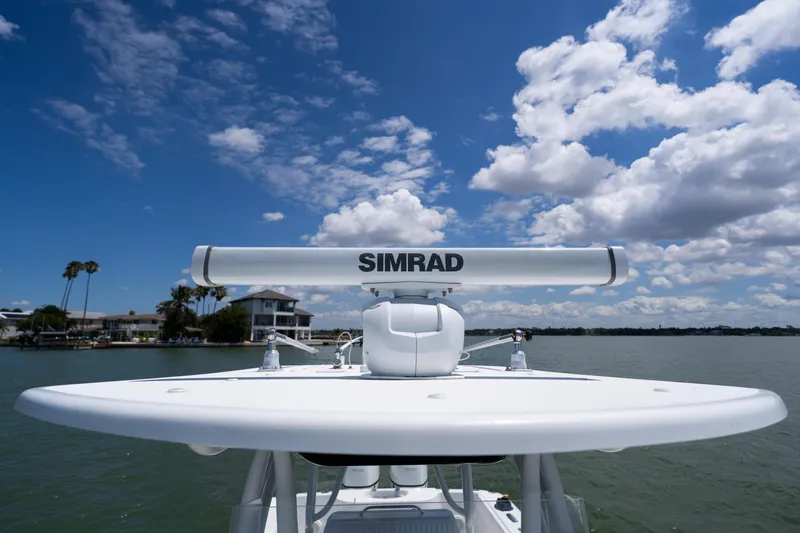 Slide: The Image of 2007 Yellowfin 34 Offshore boat with Simrad radar, under a clear blue sky. - 21