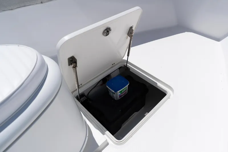 Slide: The Image of Open hatch on 2007 Yellowfin 34 Offshore boat deck, revealing storage compartment. - 23