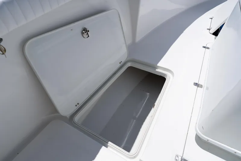 Slide: The Image of Open storage compartment on a 2007 Yellowfin 34 Offshore boat deck. - 24