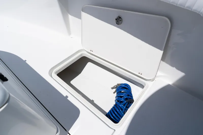 Slide: The Image of Open storage compartment on 2007 Yellowfin 34 Offshore boat with coiled blue rope. - 25