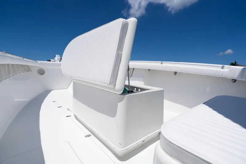 Slide: The Image of 2007 Yellowfin 34 Offshore boat with open storage compartment under clear blue sky. - 27