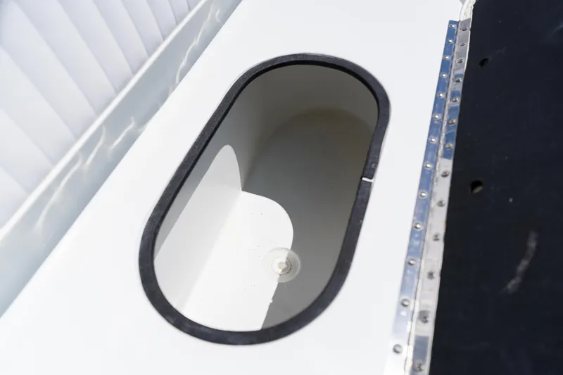 Slide: The Image of 2007 Yellowfin 34 Offshore boat storage compartment, oval-shaped with black trim. - 29