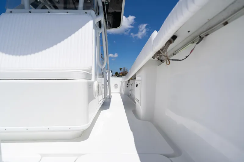 Slide: The Image of 2007 Yellowfin 34 Offshore boat interior with white seating and clear blue sky. - 30