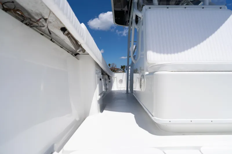 Slide: The Image of 2007 Yellowfin 34 Offshore boat deck, showcasing sleek white design under a clear blue sky. - 31