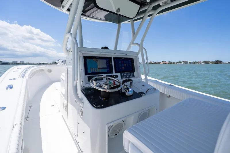 Slide: The Image of 2007 Yellowfin 34 Offshore boat cockpit with modern navigation system on open water. - 32