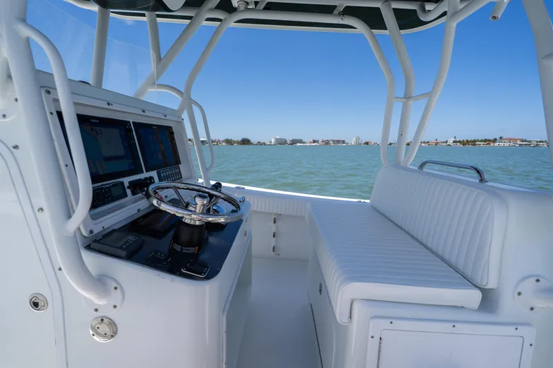 Slide: The Image of 2007 Yellowfin 34 Offshore boat interior with steering wheel and navigation screens. - 34