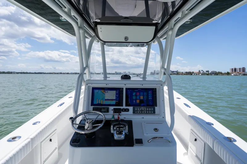 Slide: The Image of 2007 Yellowfin 34 Offshore boat helm with dual screens on calm water. - 35