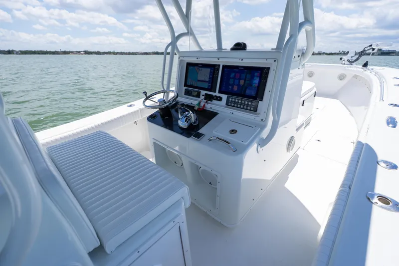Slide: The Image of 2007 Yellowfin 34 Offshore boat cockpit with modern navigation equipment on a sunny day. - 38