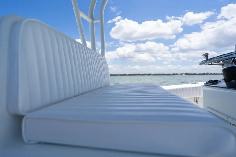 Slide: The Image of 2007 Yellowfin 34 Offshore boat with white seating, steering wheel, and ocean view. - 39