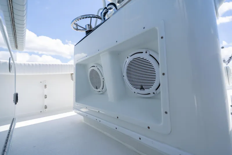 Slide: The Image of 2007 Yellowfin 34 Offshore boat interior with built-in speakers and steering wheel. - 40