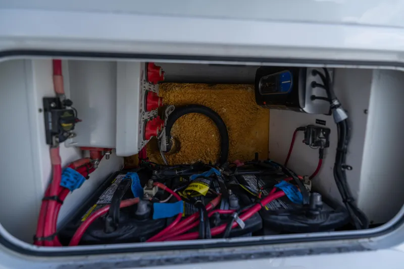 Slide: The Image of Electrical compartment of a 2007 Yellowfin 34 Offshore boat, featuring batteries and wiring. - 42