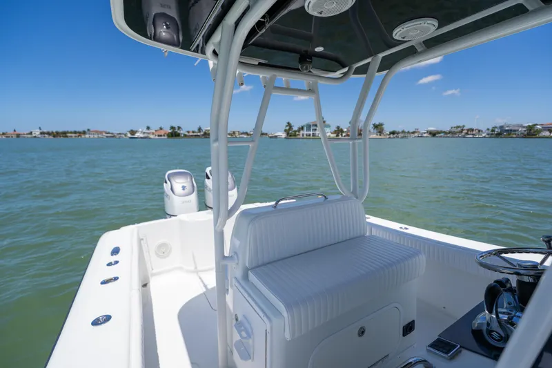 Slide: The Image of 2007 Yellowfin 34 Offshore boat interior with seating, on calm waters under clear blue sky. - 44