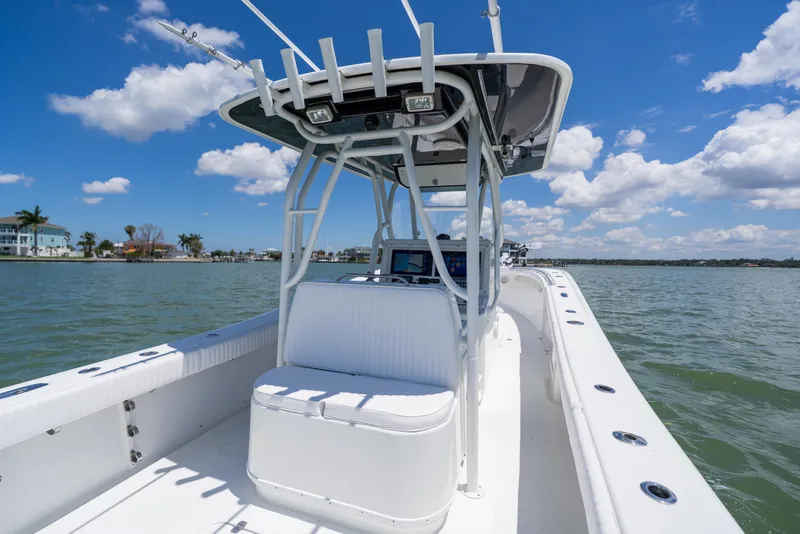 Slide: The Image of 2007 Yellowfin 34 Offshore boat on water, clear sky, and coastal background. - 47