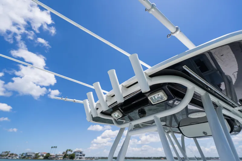 Slide: The Image of 2007 Yellowfin 34 Offshore boat with rod holders against a clear blue sky. - 49