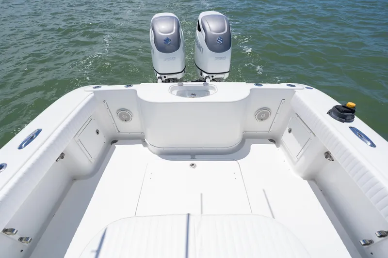 Slide: The Image of 2007 Yellowfin 34 Offshore boat deck with twin Suzuki engines on water. - 51
