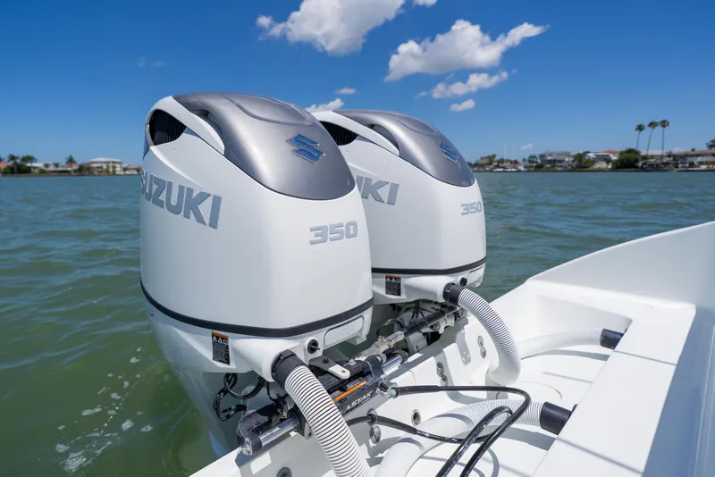 Slide: The Image of Twin Suzuki 350 outboard engines on a 2007 Yellowfin 34 Offshore boat in calm waters. - 56