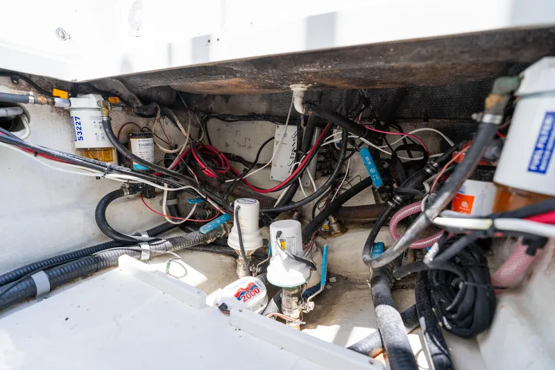 Slide: The Image of Engine compartment of a 2007 Yellowfin 34 Offshore boat, showing wiring and components. - 63