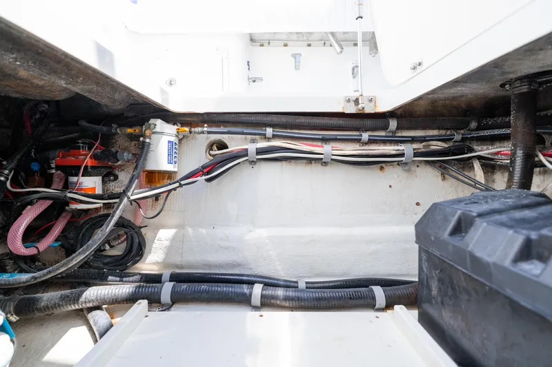 Slide: The Image of Engine compartment of a 2007 Yellowfin 34 Offshore boat, showing wiring and components. - 64