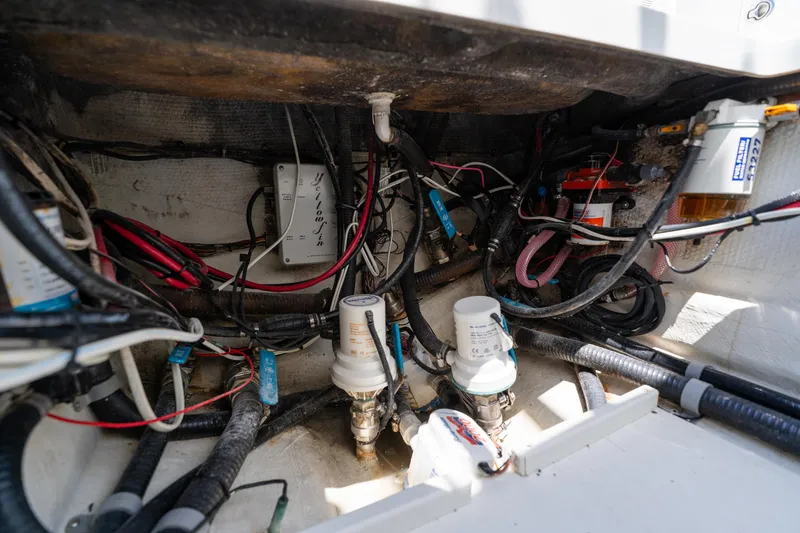 Slide: The Image of Engine compartment of a 2007 Yellowfin 34 Offshore boat, showcasing wiring and components. - 65