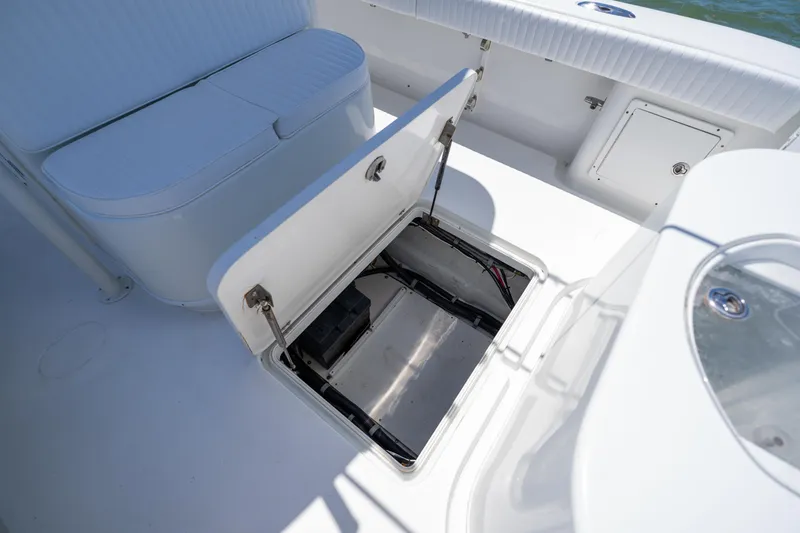 Slide: The Image of 2007 Yellowfin 34 Offshore boat with open storage compartment and seating area. - 66
