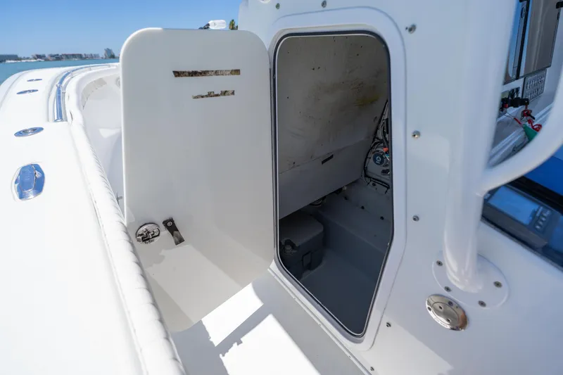 Slide: The Image of 2007 Yellowfin 34 Offshore boat interior, showcasing storage compartment and control panel. - 67