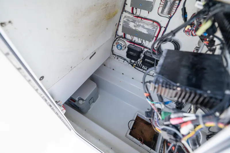 Slide: The Image of Electrical compartment of a 2007 Yellowfin 34 Offshore boat, showcasing wiring and equipment. - 69