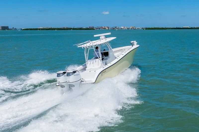 Slide: The Image of 2007 Yellowfin 34 Offshore boat cruising on open water with twin Suzuki engines. - 9
