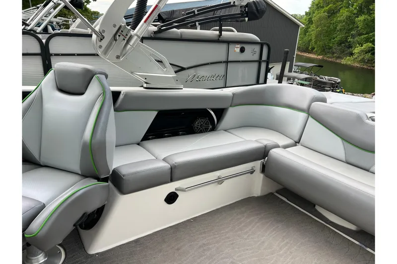 Slide: The Image of 2017 MasterCraft XT23 boat interior with gray seating and green accents. - 3