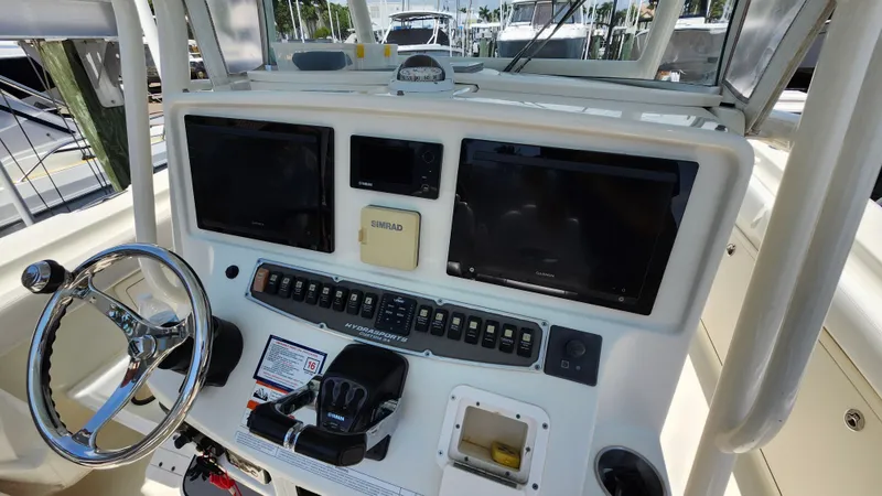 Slide: The Image of 2014 Hydra-Sports 3400 CC boat console with controls and screens. - 16